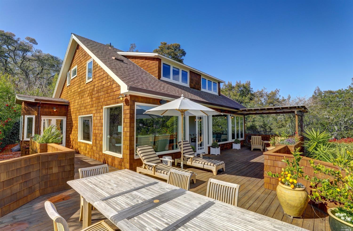 Brown-shingled home with deck